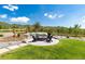Landscaped backyard fire pit area surrounded by Adirondack chairs and decorative fencing, perfect for outdoor entertaining at 5225 Mesa Top Dr, Monument, CO 80132