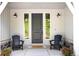 Inviting front porch with seating, decorative lighting, and a stylish front door, creating a warm and welcoming entryway at 5225 Mesa Top Dr, Monument, CO 80132