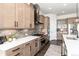 Stylish kitchen with stainless steel appliances, custom cabinetry, a center island, and tile backsplash at 5225 Mesa Top Dr, Monument, CO 80132