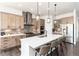 Modern kitchen with stainless steel appliances, a center island with bar seating, and stylish pendant lighting at 5225 Mesa Top Dr, Monument, CO 80132