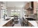 Modern kitchen featuring an island with sink, gas range, and seamlessly connects to dining area with scenic views at 5225 Mesa Top Dr, Monument, CO 80132