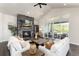 Bright living room features a stone fireplace, vaulted ceilings, and sliding glass doors to a patio with scenic views at 5225 Mesa Top Dr, Monument, CO 80132