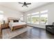 Bright main bedroom boasts hardwood flooring and a wall of windows overlooking the property at 5225 Mesa Top Dr, Monument, CO 80132