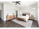 A spacious main bedroom features hardwood flooring, neutral decor, and a bright and open space at 5225 Mesa Top Dr, Monument, CO 80132