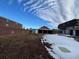Wide backyard view with partial snow cover at 571 Geneva St, Aurora, CO 80010