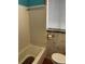 Bathroom with bathtub, toilet and window at 571 Geneva St, Aurora, CO 80010