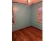 Bedroom with hardwood floors and teal walls at 571 Geneva St, Aurora, CO 80010