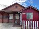 Brick and red siding home with a unique design and landscaping at 571 Geneva St, Aurora, CO 80010