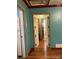 Hallway with hardwood floors and doors to other rooms at 571 Geneva St, Aurora, CO 80010