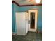 Kitchen with teal walls, white refrigerator, and door at 571 Geneva St, Aurora, CO 80010