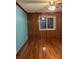 Living room with hardwood floors and wood paneling at 571 Geneva St, Aurora, CO 80010