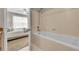 Inviting bathroom featuring a bathtub and shower combination adjacent to a cozy bedroom at 3852 S Dallas St # 8-102, Aurora, CO 80014