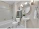 Modern bathroom with stylish pedestal sink, shower, tub, and hexagonal tiled floor at 3852 S Dallas St # 8-102, Aurora, CO 80014