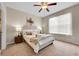 Cozy bedroom featuring neutral tones, a plush bed, and a window with sheer curtains at 3852 S Dallas St # 8-102, Aurora, CO 80014