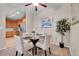 Charming dining area adjacent to kitchen with a round glass table set for four at 3852 S Dallas St # 8-102, Aurora, CO 80014