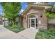 Attractive building entrance with brick facade and well-maintained landscaping at 3852 S Dallas St # 8-102, Aurora, CO 80014