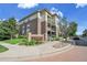 Brick condo building with beautiful landscaping and a sign that reads 'Town Center Terrace' at 3852 S Dallas St # 8-102, Aurora, CO 80014