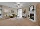 Bright living room featuring a fireplace, ceiling fan, and access to a balcony at 3852 S Dallas St # 8-102, Aurora, CO 80014