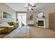 Inviting living room with a cozy fireplace, ceiling fan, and glass sliding doors at 3852 S Dallas St # 8-102, Aurora, CO 80014