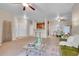 Open-concept living space featuring a bar, ceiling fan, and dining area at 3852 S Dallas St # 8-102, Aurora, CO 80014