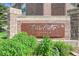 Signage for Town Center Terrace Condominiums surrounded by lush plants at 3852 S Dallas St # 8-102, Aurora, CO 80014