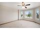Spacious bedroom with a ceiling fan and large windows offering a scenic view at 102 Staghorn Way, Franktown, CO 80116