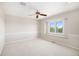 Inviting bedroom featuring neutral carpet, ceiling fan, and a window with scenic views at 102 Staghorn Way, Franktown, CO 80116