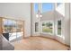 Bright dining area featuring a high ceiling with large windows and hardwood floors at 102 Staghorn Way, Franktown, CO 80116