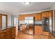Well-equipped kitchen featuring stainless steel appliances, wooden cabinets, and hardwood floors at 102 Staghorn Way, Franktown, CO 80116