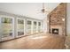 Spacious living room with a stone fireplace, many windows and hardwood floors at 102 Staghorn Way, Franktown, CO 80116