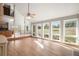 Bright and spacious living room with a ceiling fan, many windows, and hardwood floors at 102 Staghorn Way, Franktown, CO 80116