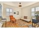 Bright bedroom features hardwood floors, an orange chair, and futon style sofa at 2531 Niagara St, Denver, CO 80207