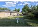 A spacious backyard with a well-maintained lawn, brick exterior, solar panels, and patio at 6579 S Lincoln St, Centennial, CO 80121