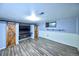 Finished basement area features barn doors, built-in shelving, and wood laminate flooring at 6579 S Lincoln St, Centennial, CO 80121