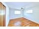 Bright bedroom with hardwood floors, natural light, and ceiling fan at 6579 S Lincoln St, Centennial, CO 80121