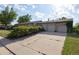 Driveway with a wide three-car garage and mature trees adding curb appeal at 6579 S Lincoln St, Centennial, CO 80121