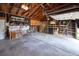 Well-lit two car garage with high ceilings, storage shelves and ample workbench space at 6579 S Lincoln St, Centennial, CO 80121