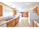 Functional kitchen with natural light and wood cabinetry overlooking the living area at 6579 S Lincoln St, Centennial, CO 80121