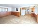 Open living room featuring tile floors, wood paneling, and access to the kitchen at 6579 S Lincoln St, Centennial, CO 80121