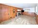 Cozy living area with wood-paneled walls, a brick fireplace, and tile flooring at 6579 S Lincoln St, Centennial, CO 80121