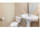 Small bathroom with pedestal sink and toilet at 6500 E Asbury Ave, Denver, CO 80224