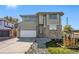 Two-story house with a brick and light-colored siding exterior, and a landscaped lawn at 6500 E Asbury Ave, Denver, CO 80224