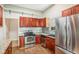 Kitchen with stainless steel appliances and wood cabinets at 6500 E Asbury Ave, Denver, CO 80224