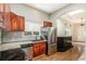 Kitchen with dark wood cabinets, granite countertops, and stainless steel appliances at 6500 E Asbury Ave, Denver, CO 80224