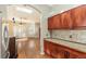 Kitchen with dark wood cabinets, granite countertops, and stainless steel appliances at 6500 E Asbury Ave, Denver, CO 80224