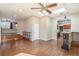 Open concept living room with hardwood floors, kitchen island, and skylight at 6500 E Asbury Ave, Denver, CO 80224