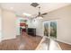 Open concept living room with hardwood floors, kitchen island, and sliding glass door at 6500 E Asbury Ave, Denver, CO 80224