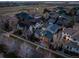 An aerial view of a neighborhood surrounded by green spaces and a winding creek at 9715 E 33Rd Ave, Denver, CO 80238