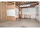 Unfinished basement with concrete floor, framing and hanging pipes ready for build out at 9715 E 33Rd Ave, Denver, CO 80238