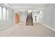 Spacious carpeted basement with large stairs, ready for customization and potential living space at 9715 E 33Rd Ave, Denver, CO 80238